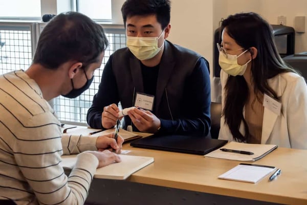 NovaXS Founder & CEO Alina Rui Su (right) and Co-founder & President Tianyi Jonathan Xing (left) working with a mentor during the 2021 mHUB MedTech Accelerator Program.