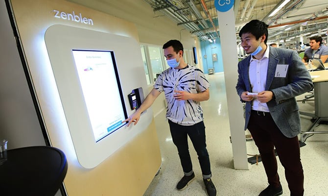 Zenblen Co-Founder and CEO Tom Xinyuan Zhang and Associate Mechanical Engineer Ben Salazar showcasing their tech-enabled smoothie bar at mHUB's 2021 IIoT Demo Day.